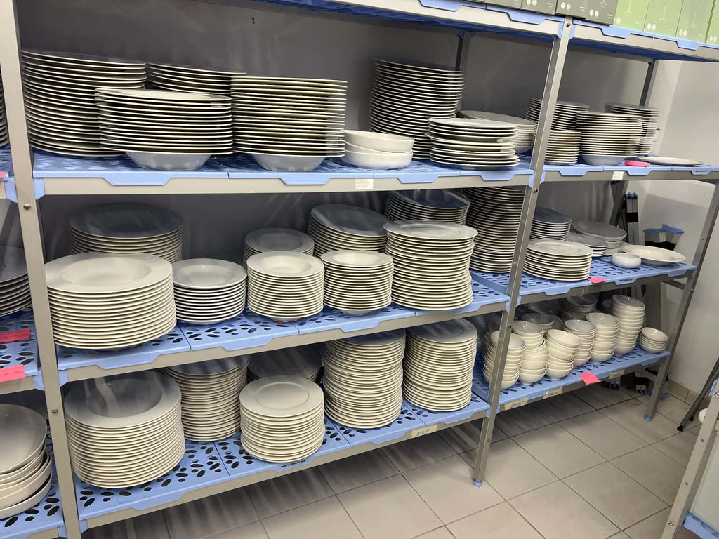 Tournus commercial shelving organised with crockery, plating items and boxed supplies in a professional storage area